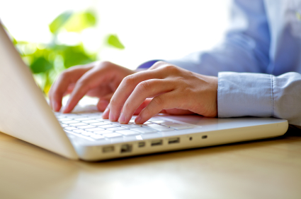 Man Typing on Laptop