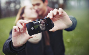 Young Couple Holding Smartphone