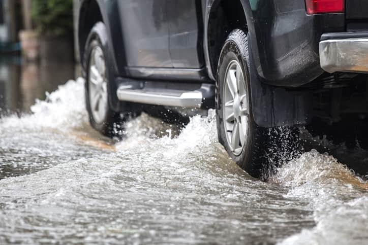 Silver Car Driving in a Flood