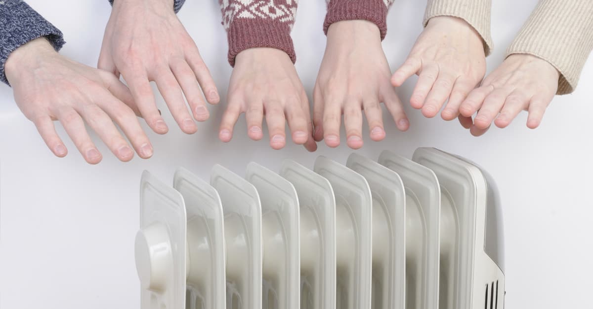 hands-heating-around-electric-heater