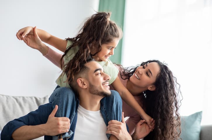 Young Family Sitting on a Couch