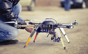 Man Standing Over His Drone While Investigating An Insurance Claim