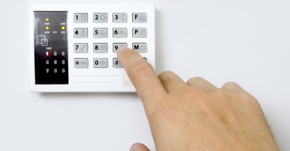 Man Setting House Alarm