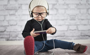 Child Using Smartphone And Big Earphones