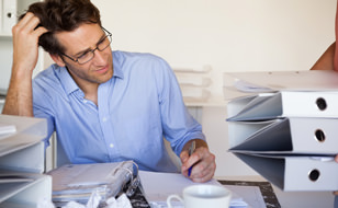 Man With Cluttered Desktop