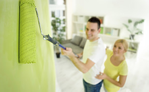 Couple Painting A Living Room Which Has House Insurance From Chill Insurance