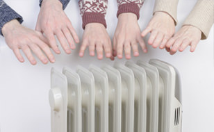 Hands Being Heated By Electric Heater