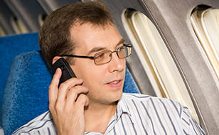 Man Using Phone on Flight