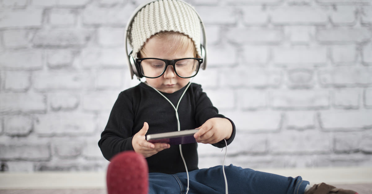 Child-Playing-On-Smartphone-With-Big-Earphones