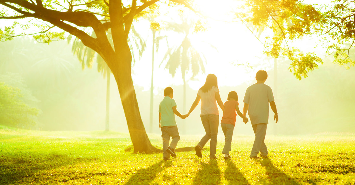 Happy Family Walking With The Knowledge That They Have Life Insurance