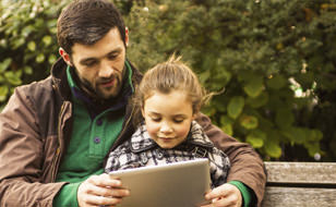 Father Talking To Child On A Park Bench
