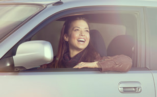 Smiling Woman In Her Car