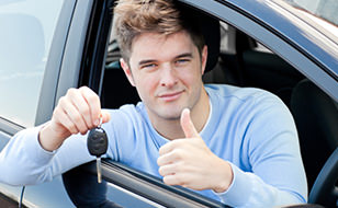 Young Driver with His Thumbs Up