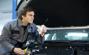 Man Carrying Out Vehicle Safety Checklist For Van With Cover From Chill Insurance