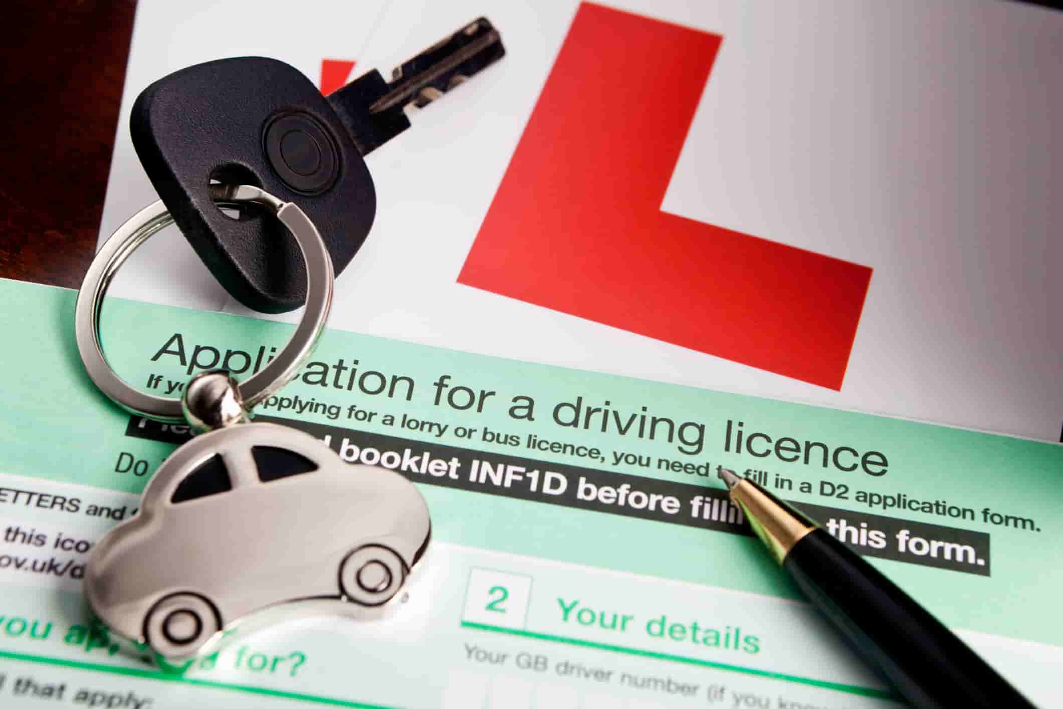 L plate, car keys and driving licence application form