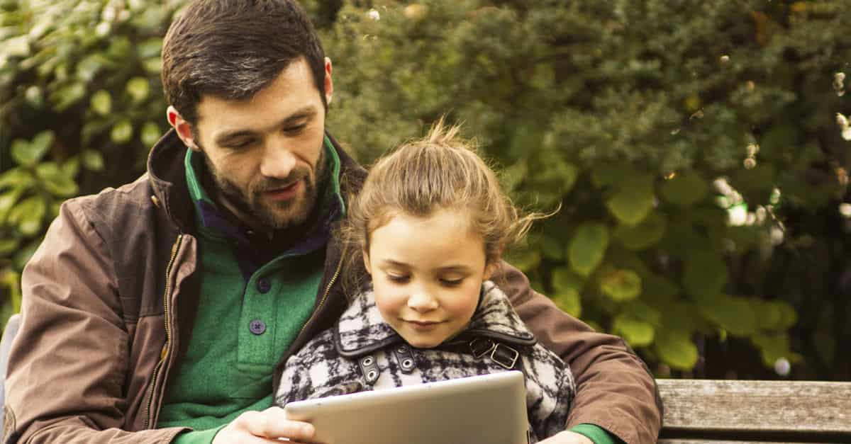 Father-Speaking-To-Child-On-A-Park-Bench