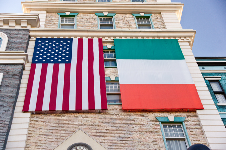 Flags of the USA and Ireland against the background of a building